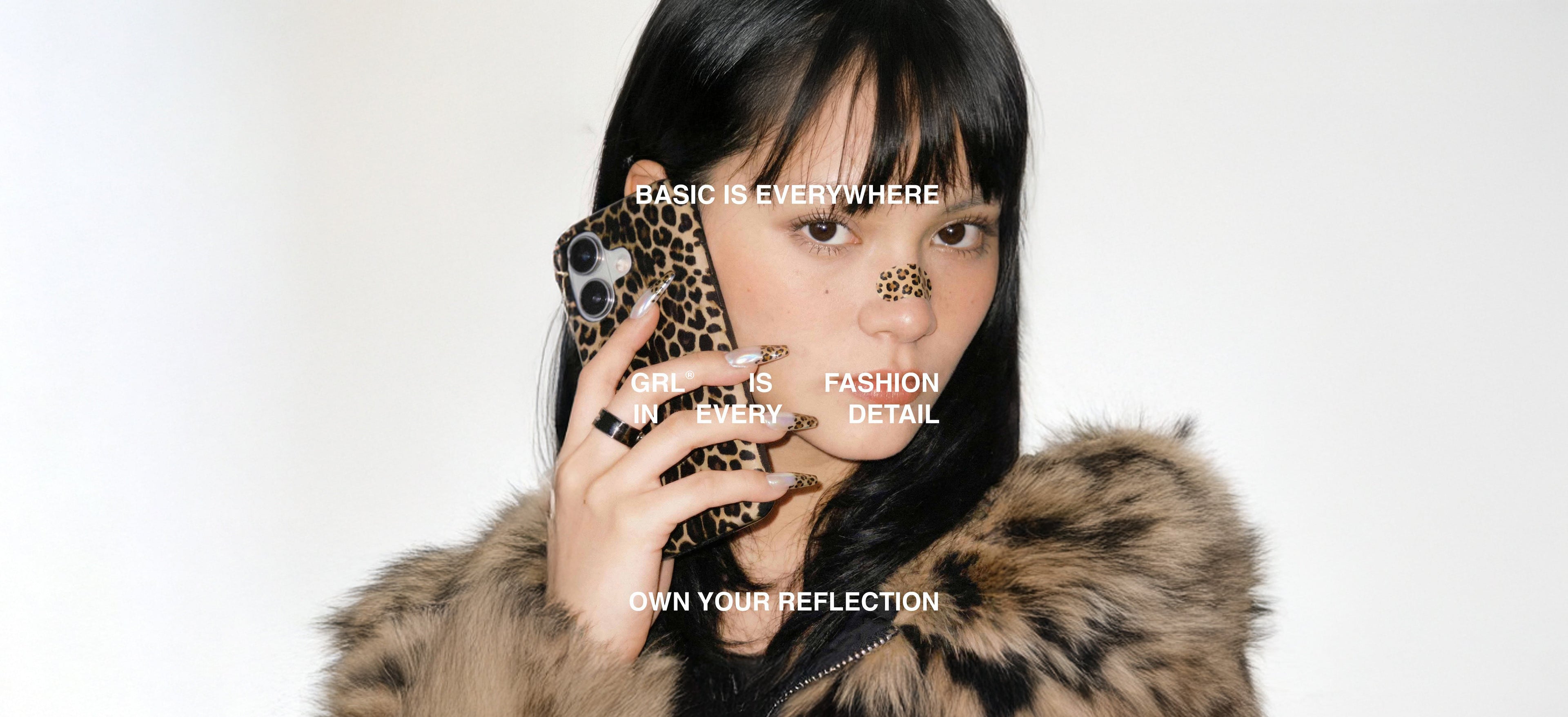 Editorial image of a woman holding a leopard print phone case, GRL® Wild collection